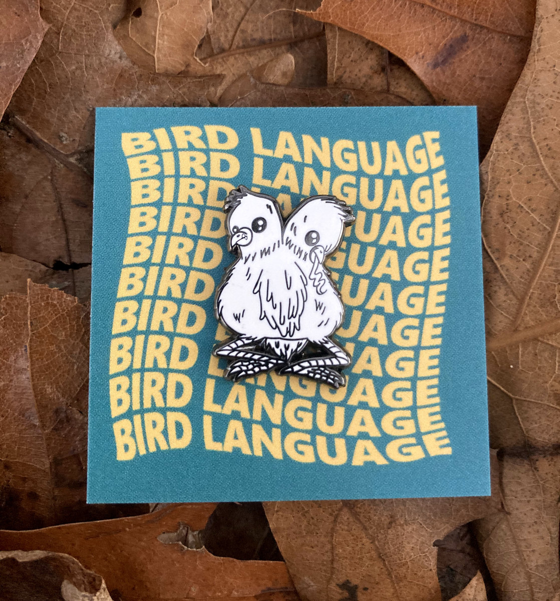 two heads pin | bird language