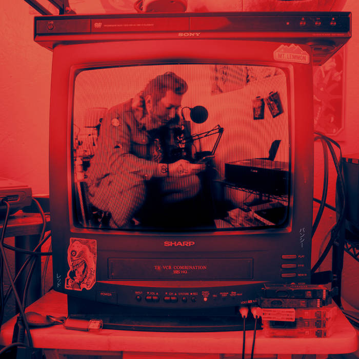 a red and black album cover featuring an image of ruby on a CRT television