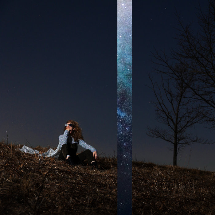 Particles and Waves album cover — a figure on a dark hillside beneath a starry sky, split by a bright band of nebula