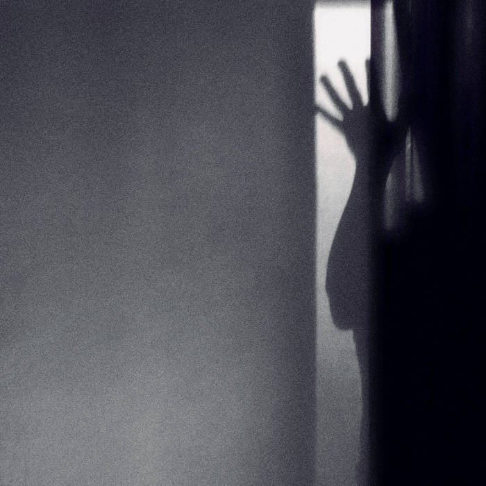 HEFT - Ombre cover artwork. Monochrome shaded shot of a wall, shadow of a person, hand up.