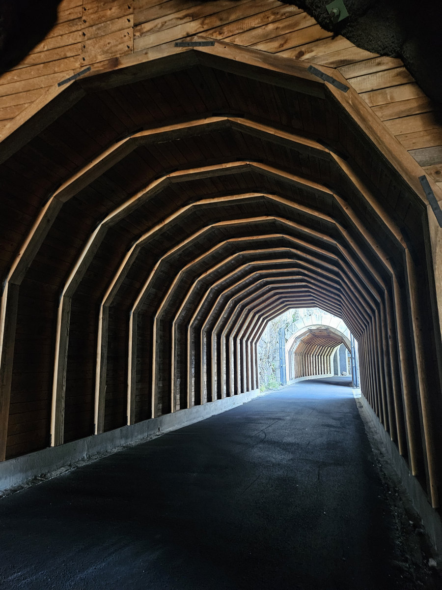 Between Places EP artwork, a view through an arched stone tunnel