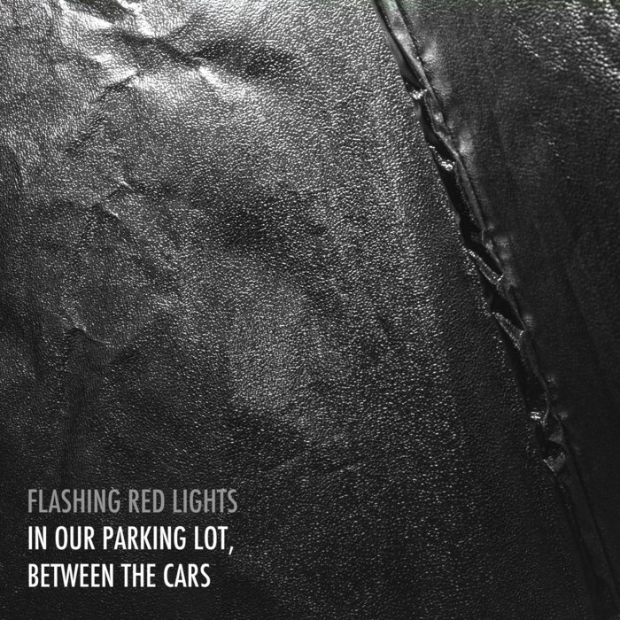 In Our Parking Lot, Between the Cars Flashing Red Lights