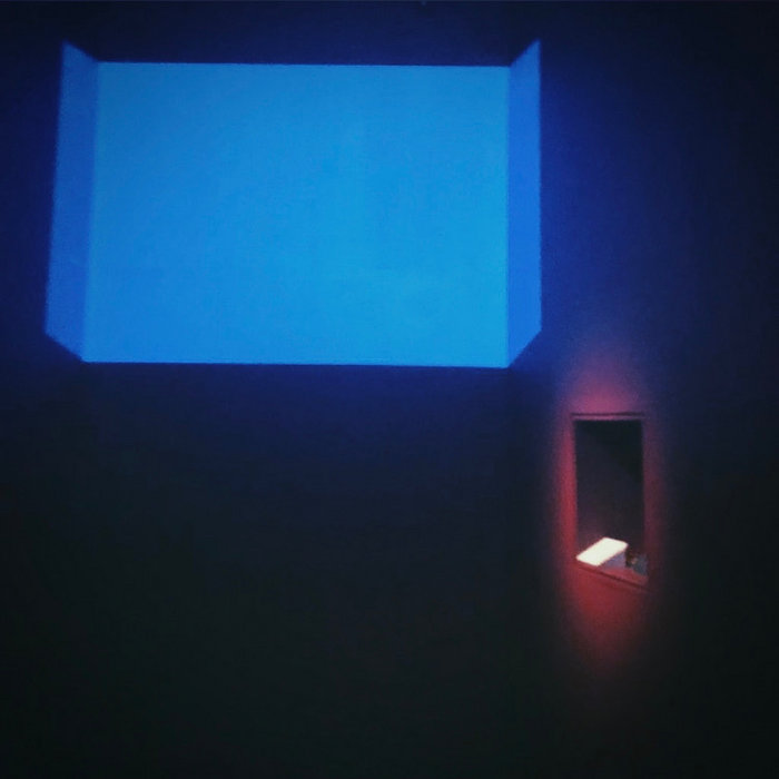 an album cover of a window, it is assumed to be raining because of the shade of blue outside. there is an illuminated section on the wall next to it